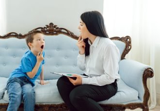 Picture of child psychologist working with young boy in office